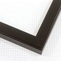 A simple 1-1/4 " wood frame with a concave top, features a smooth texture that enhances the dark black finish.