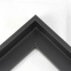 This L-shaped modern canvas floater frame, features a black smooth curved wall.     *Note: These solid wood, custom canvas floaters are for stretched canvas prints and paintings, and raised wood panels.